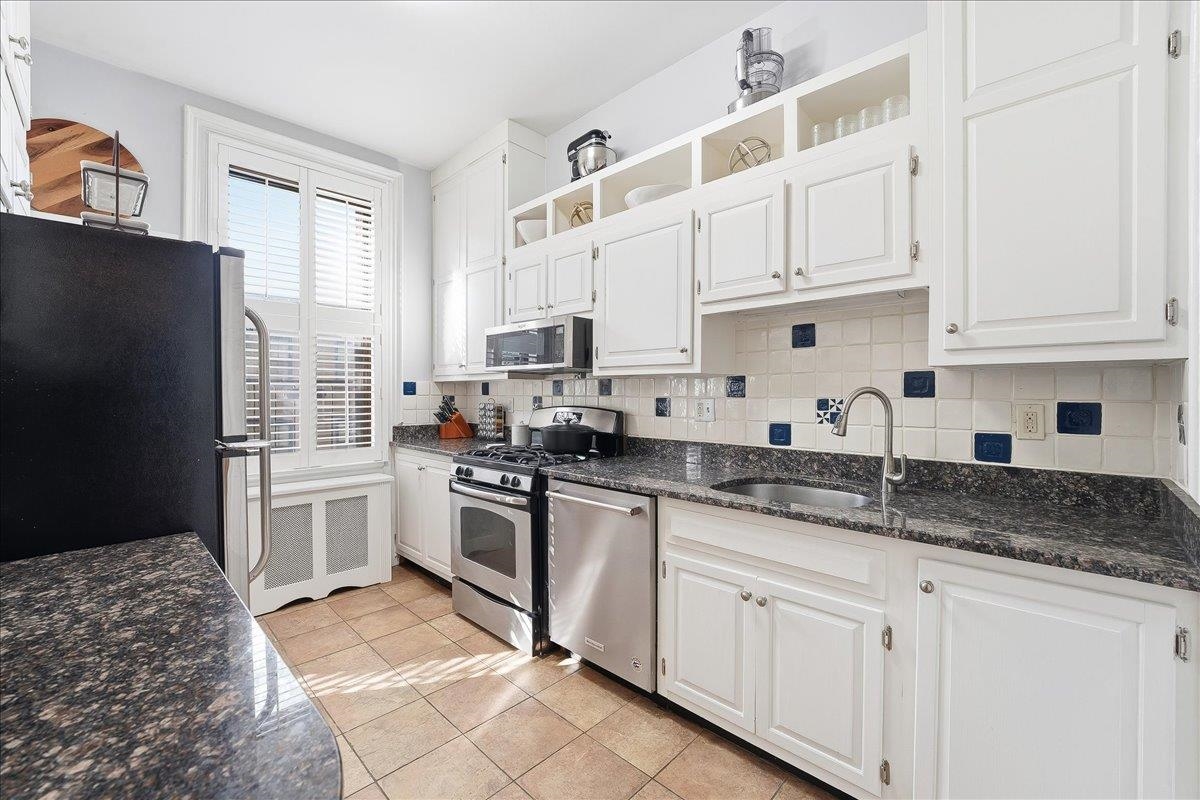 826 Washington Street, Unit 2 Hoboken, NJ 07030 - Photo 28 of 42 a kitchen with granite countertop white cabinets and white appliances