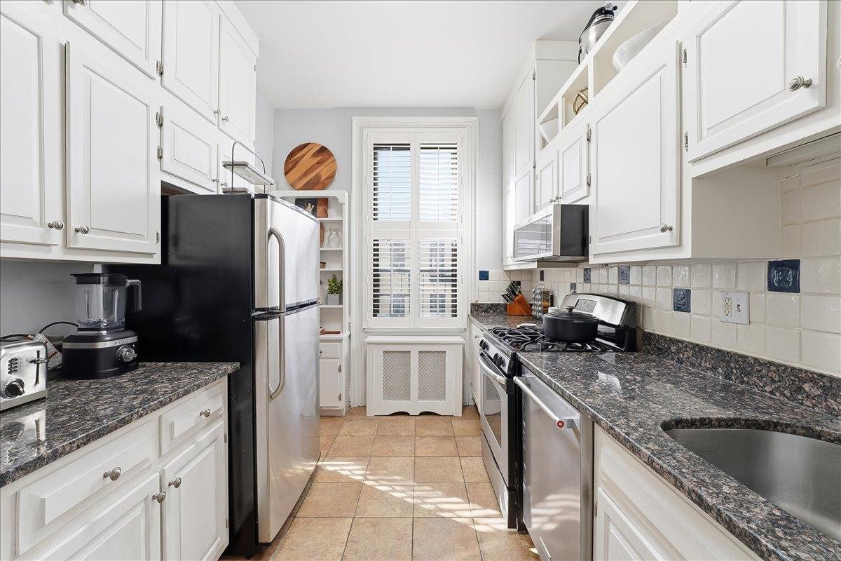 826 Washington Street, Unit 2 Hoboken, NJ 07030 - Photo 29 of 42 a kitchen with stainless steel appliances granite countertop a refrigerator stove and sink