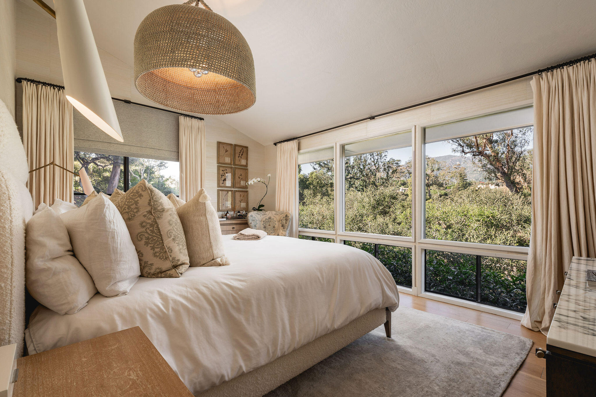 395 Woodley Road Montecito, CA 93108 - Photo 13 of 30 a bedroom with a large bed and a chandelier
