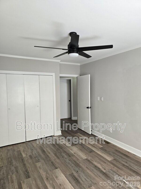 5949 Quail Hollow Road, Unit D Charlotte, NC 28210 - Photo 20 of 34 a bedroom with a bed and wooden floor