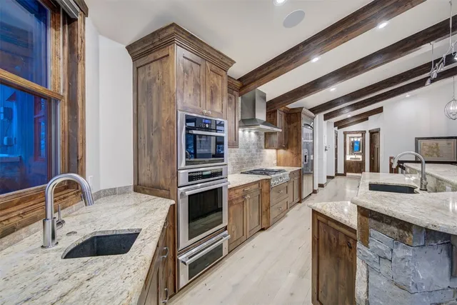a kitchen with granite countertop a sink and stove