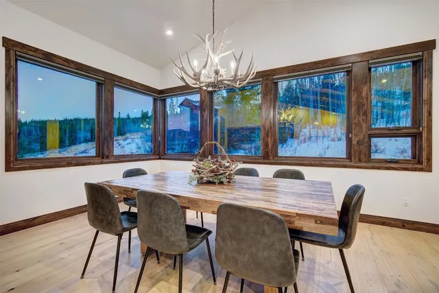 a view of a dining room with furniture wooden floor and chandelier