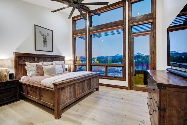 a bedroom with a bed window and a flat tv screen