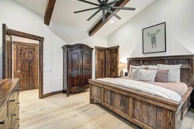 a bedroom with a bed a ceiling fan and a dresser