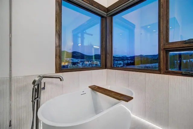 a bathroom with a bathtub and a window
