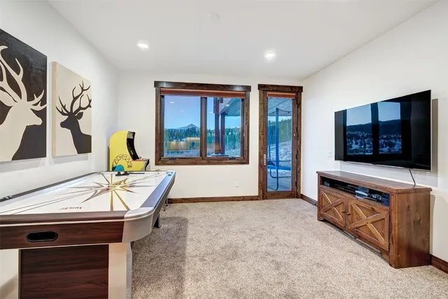 a large kitchen with stainless steel appliances granite countertop a large counter top a stove a chimney a sink and a refrigerator