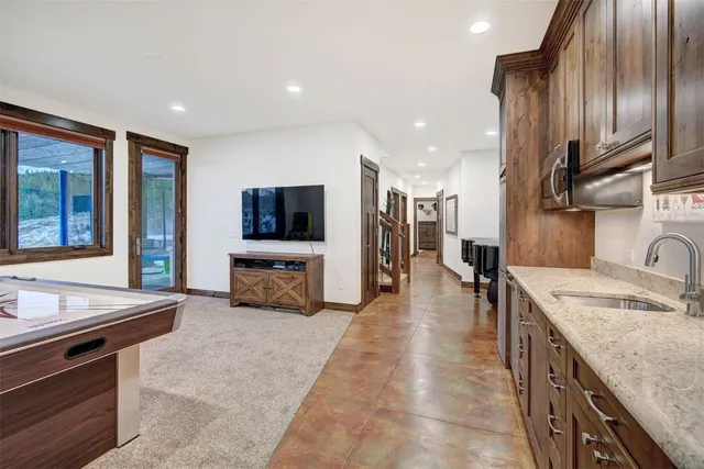 a kitchen with stainless steel appliances granite countertop a sink and a microwave