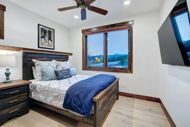 a bedroom with a large bed and a chandelier