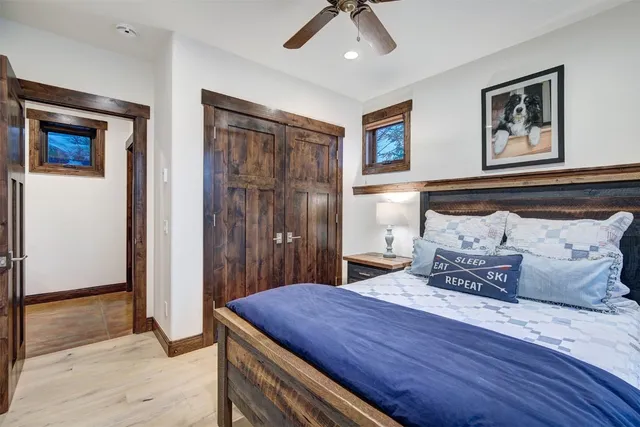 a bathroom with a granite countertop sink toilet and mirror