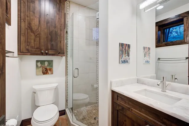 a bedroom with a bed a book shelf and a window