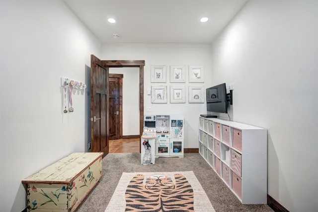 a bedroom with furniture and a flat screen tv