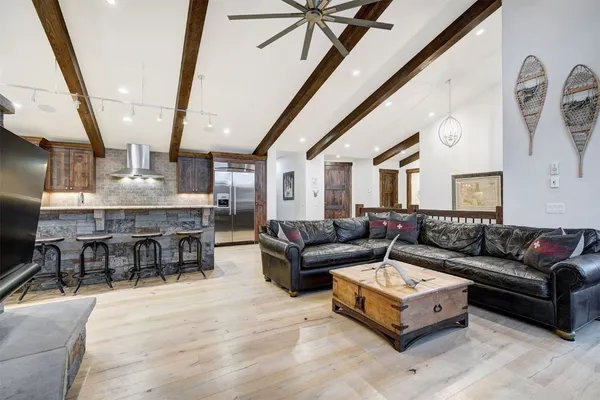 a living room with furniture and a chandelier