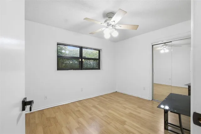 a view of a room with wooden floor and windows