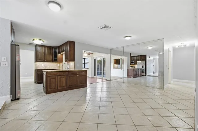 a large white kitchen with a stove a sink dishwasher and a refrigerator