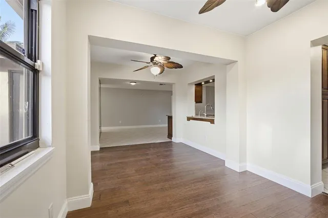 a view of a hallway with wooden floor and closet