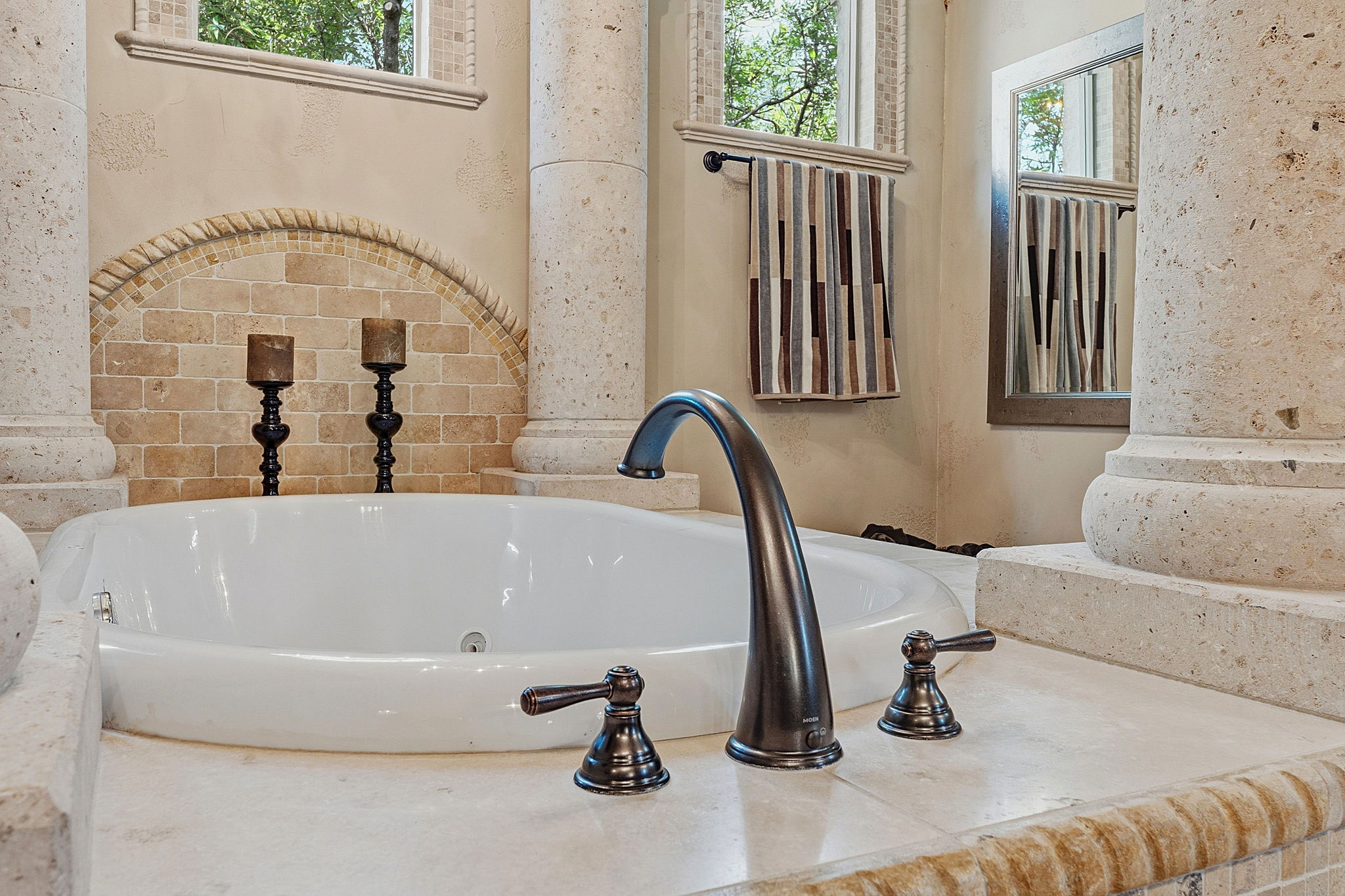 816 Brave Face Street Leander, TX 78641 - Photo 22 of 40 Experience luxurious relaxation in this master bathroom featuring an inviting soaking tub and ornate architectural pillars.