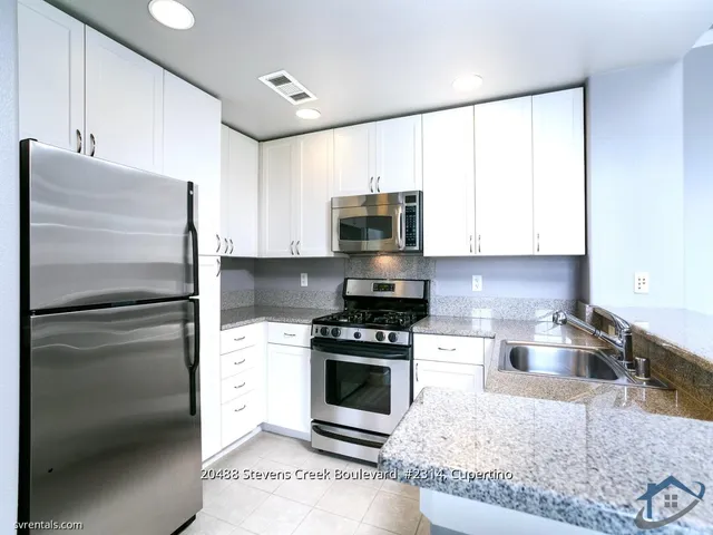 a kitchen with a refrigerator stove and microwave