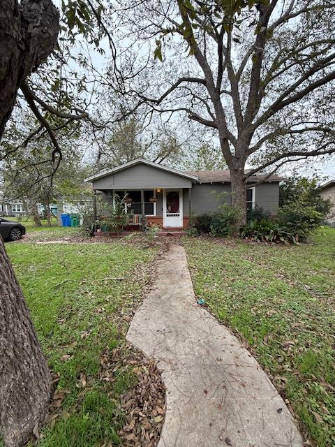 1026 Victoria Street Taylor, TX 76574 - Photo 1 of 1 a front view of a house with garden