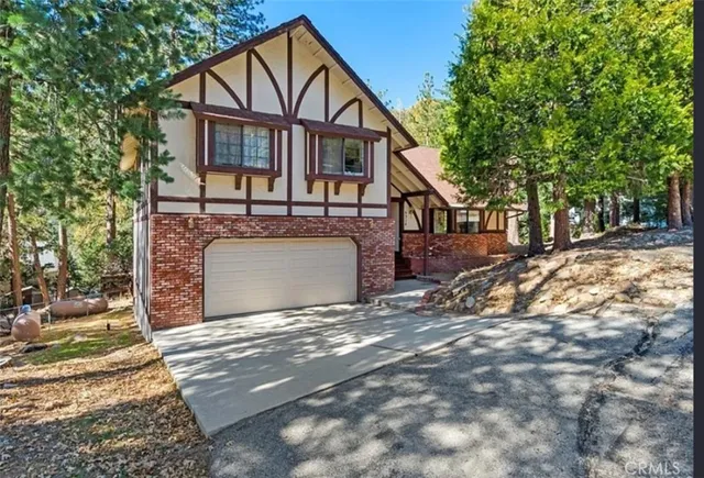 a view of a house with a yard and tree s