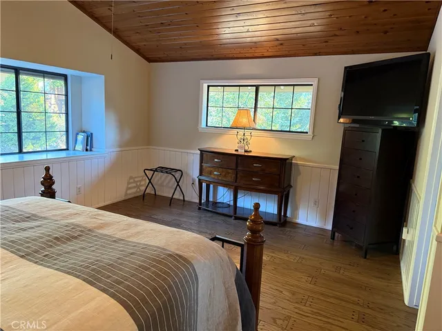 a bedroom with a bed window and a table