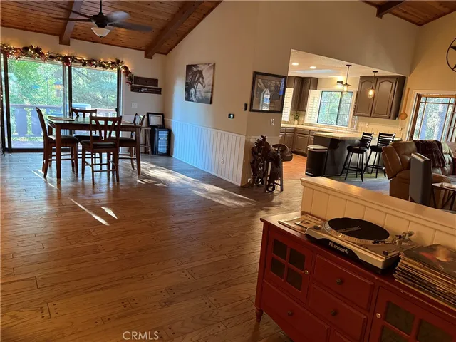 a dining room with furniture and wooden floor