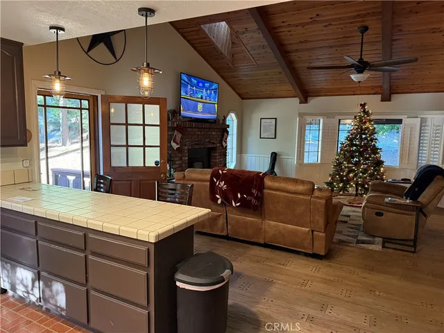 a living room with furniture a fireplace and windows
