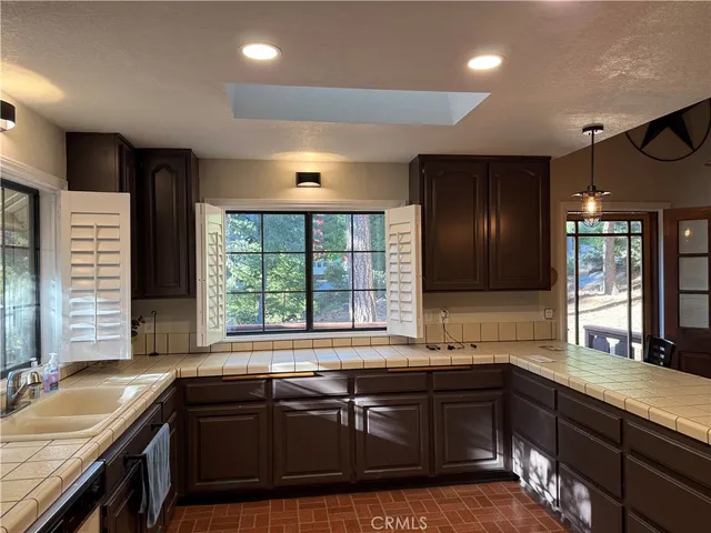 a kitchen with a sink and large window