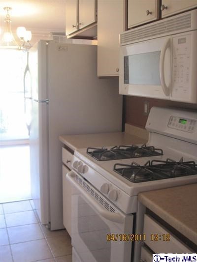 3010 Montrose, Unit 33 La Crescenta, CA 91214 - Photo 3 of 11 a stove top oven sitting inside of a kitchen