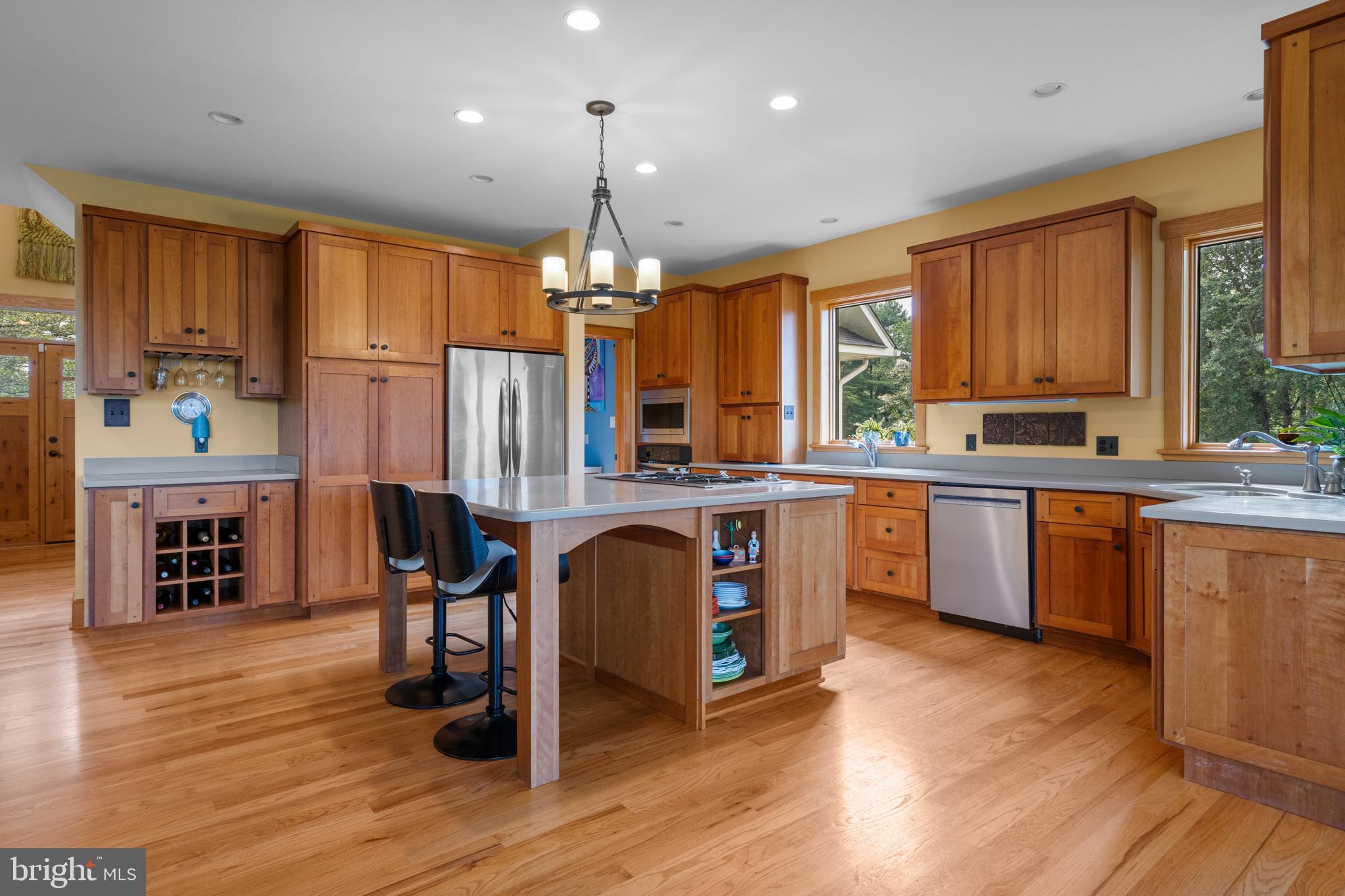 210 Grandview Road Washington, VA 22747 - Photo 10 of 62 a open kitchen with stainless steel appliances granite countertop a refrigerator a sink dishwasher a stove and a dining table with wooden floor
