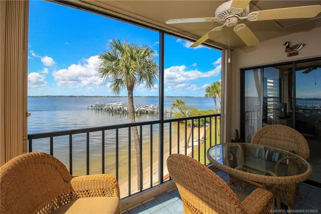 a view of a lake with lawn chairs