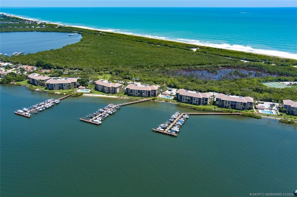 4540 Northeast Sandpebble Trace, Unit 302 Stuart, FL 34996 - Photo 13 of 34 a view of a lake with lawn chairs