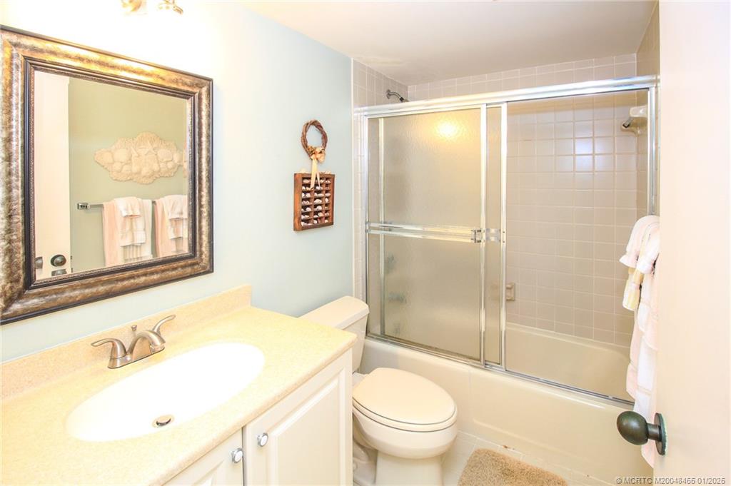 4540 Northeast Sandpebble Trace, Unit 302 Stuart, FL 34996 - Photo 20 of 34 a bathroom with a sink toilet and shower