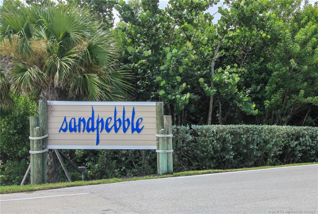 4540 Northeast Sandpebble Trace, Unit 302 Stuart, FL 34996 - Photo 23 of 34 a sign on the side of a road
