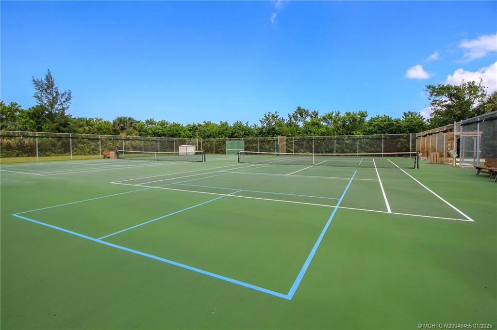 4540 Northeast Sandpebble Trace, Unit 302 Stuart, FL 34996 - Photo 28 of 34 a view of an outdoor space and tennis court