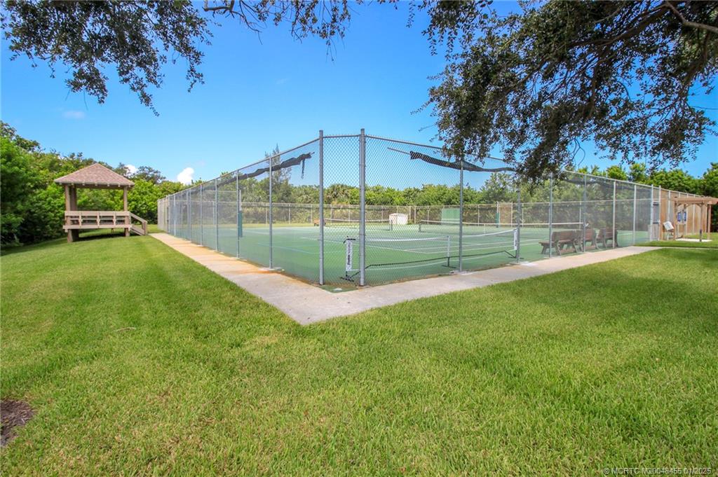 4540 Northeast Sandpebble Trace, Unit 302 Stuart, FL 34996 - Photo 29 of 34 a view of yard with swimming pool and green space