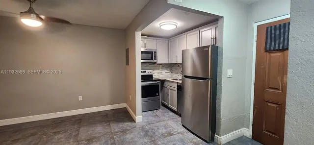 a kitchen with a refrigerator and a refrigerator