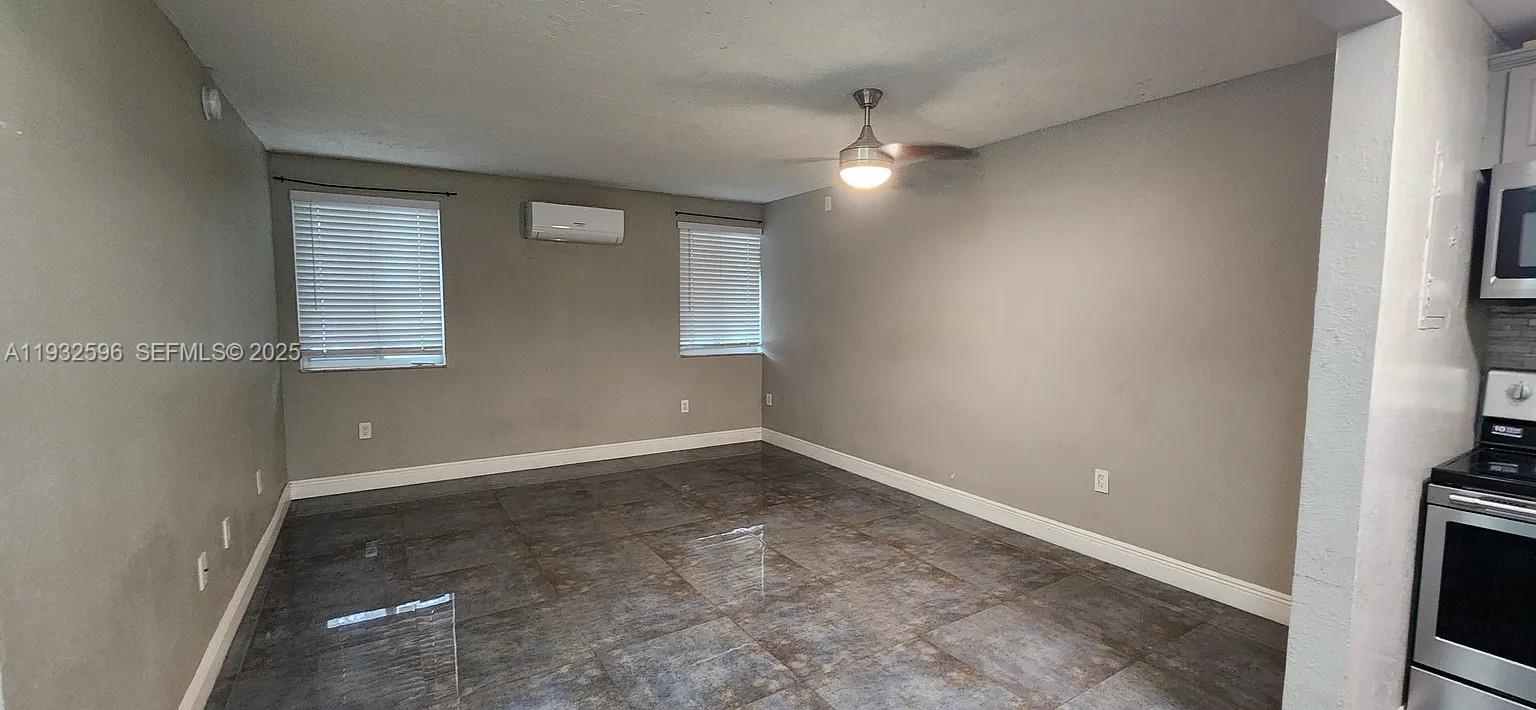 1 Northeast 78th Street, Unit B Miami, FL 33138 - Photo 3 of 8 an empty room with windows and fan