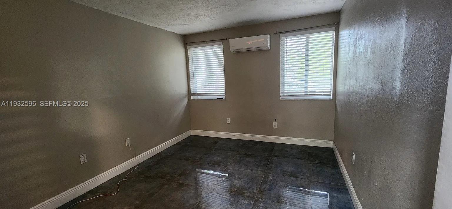 1 Northeast 78th Street, Unit B Miami, FL 33138 - Photo 6 of 8 an empty room with a window