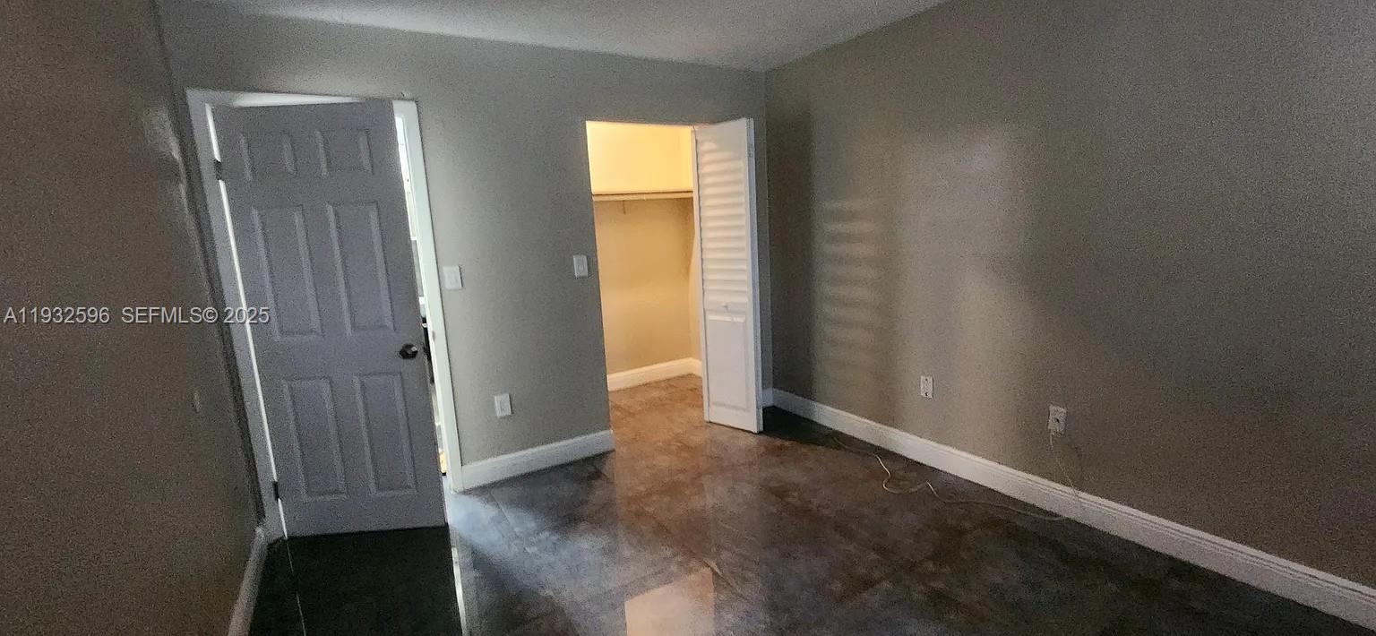 1 Northeast 78th Street, Unit B Miami, FL 33138 - Photo 7 of 8 an empty room with windows