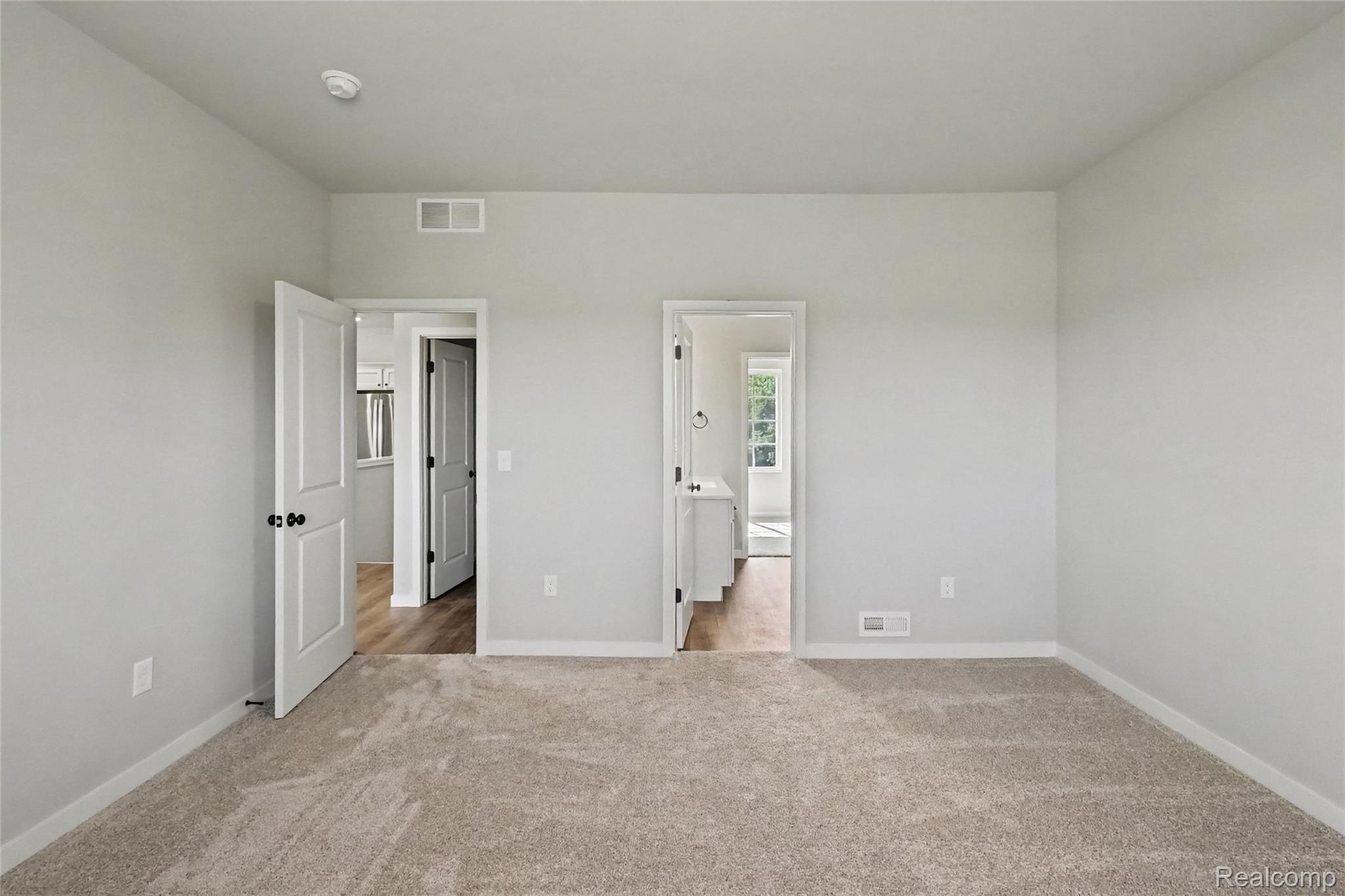 5528 Lahring Road Linden, MI 48451 - Photo 7 of 39 The primary suite is located on the upper level and includes a private bath and oversized walk-in closet with large window for natural lighting.