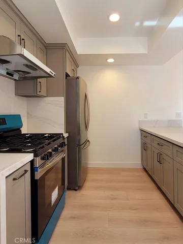a kitchen with stainless steel appliances granite countertop a stove and a refrigerator