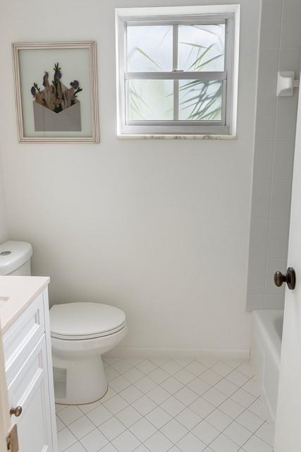 1407 Northeast 56th Street, Unit 217 Fort Lauderdale, FL 33334 - Photo 7 of 8 a white toilet sitting next to a bathroom sink