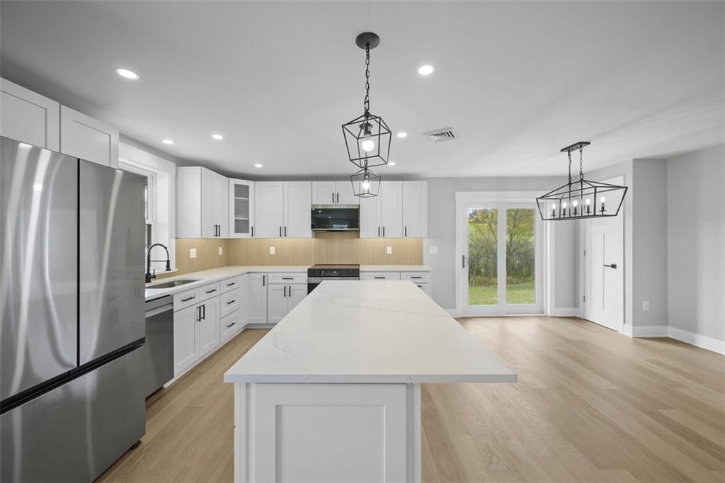 134 Kings Creek Road Georgetown, PA 15043 - Photo 13 of 44 a kitchen with refrigerator a sink and cabinets