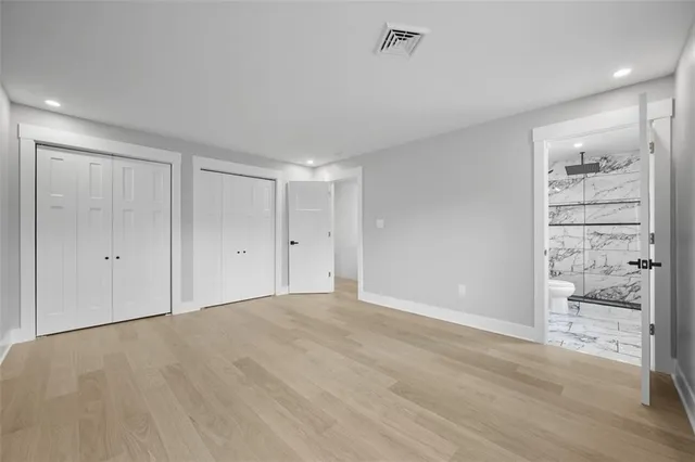a view of an empty room and wooden floor