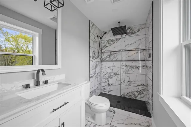 a bathroom with a sink toilet and shower
