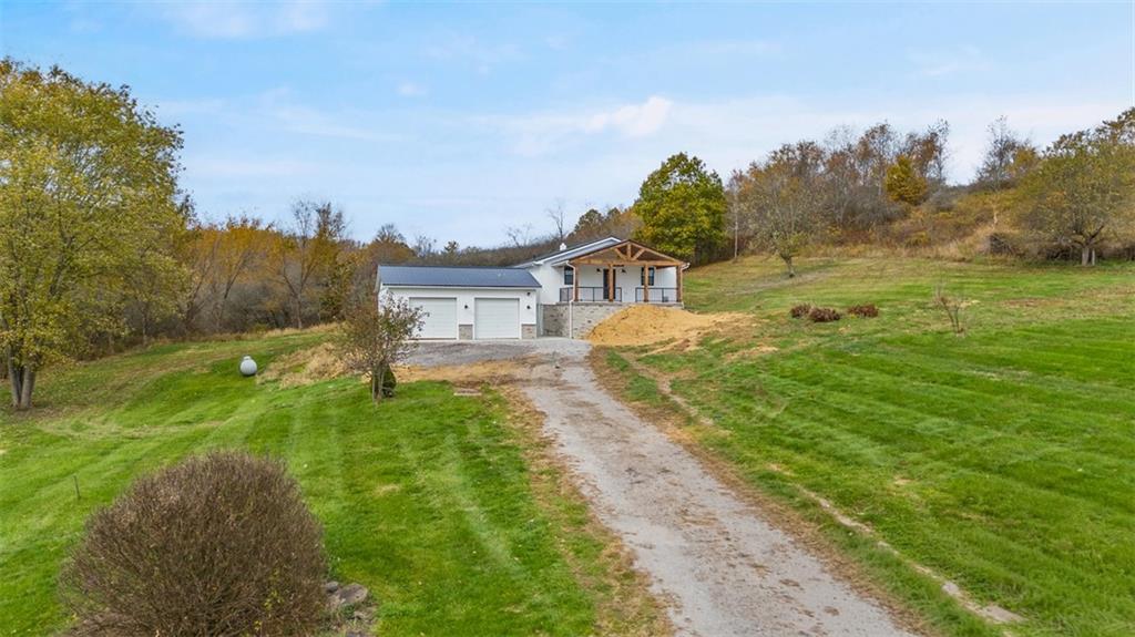 134 Kings Creek Road Georgetown, PA 15043 - Photo 2 of 44 a view of a big yard with potted plants and big trees