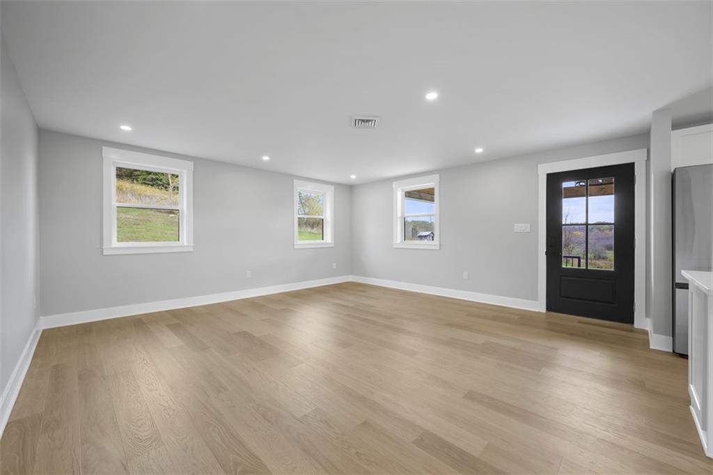 134 Kings Creek Road Georgetown, PA 15043 - Photo 9 of 44 a view of an empty room with wooden floor and a window