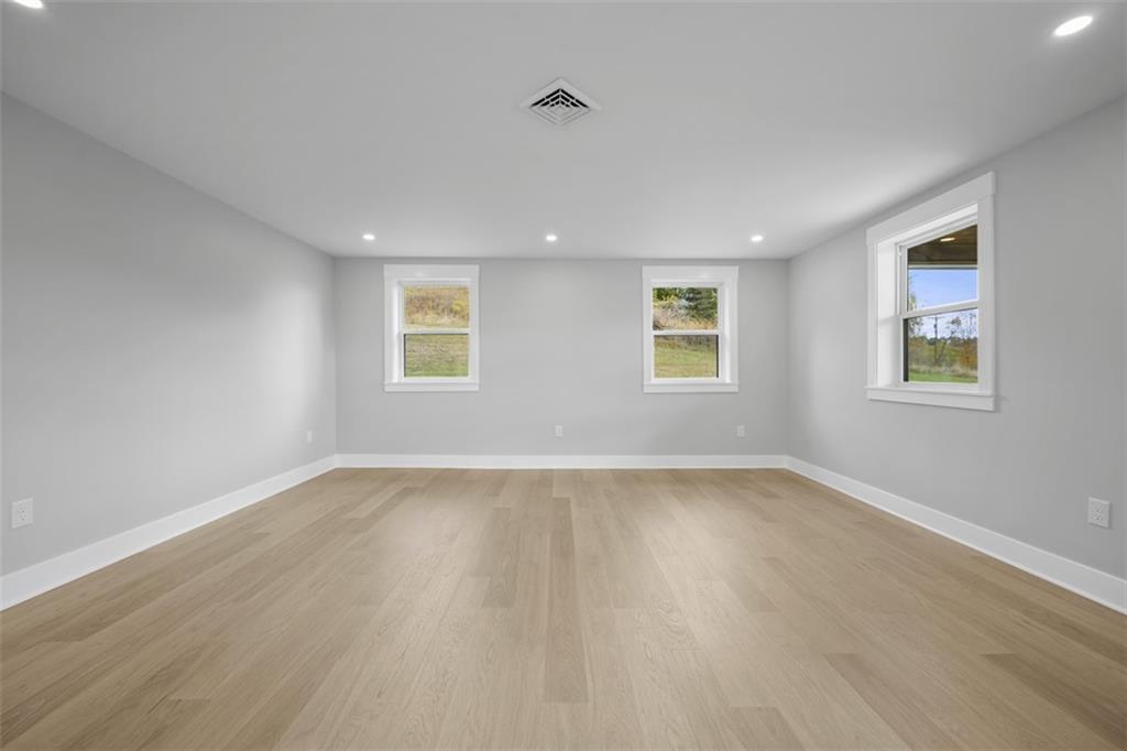 134 Kings Creek Road Georgetown, PA 15043 - Photo 10 of 44 a view of an empty room with wooden floor and a window