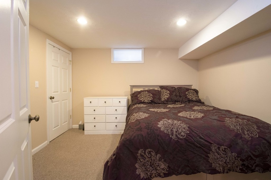 155 Eastbourne Road Newton, MA 02459 - Photo 23 of 25 a bedroom with a bed and cabinets