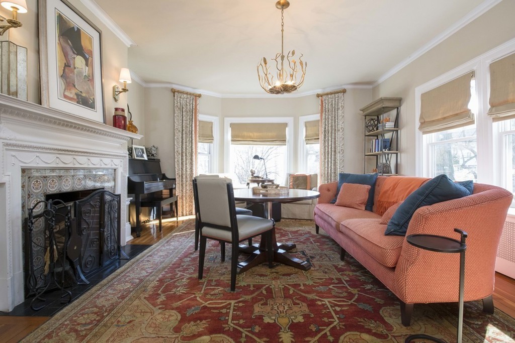 155 Eastbourne Road Newton, MA 02459 - Photo 5 of 25 a living room with furniture a chandelier and a fireplace